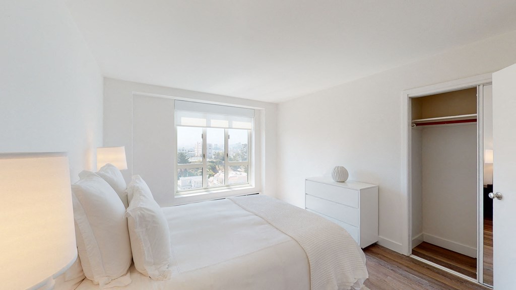 a bedroom with a bed and a window