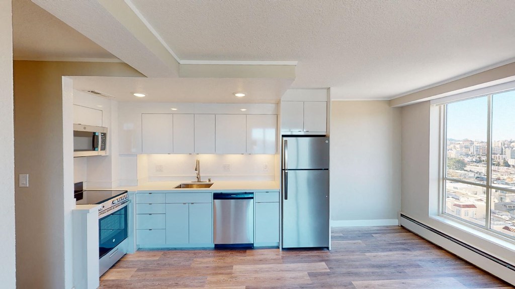 a kitchen with white cabinets and blue appliances