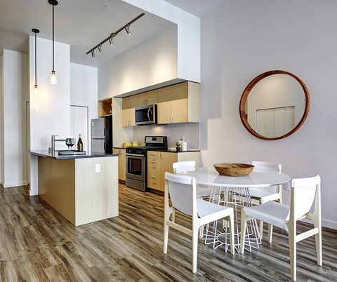 a kitchen and dining room with a white table and chairs