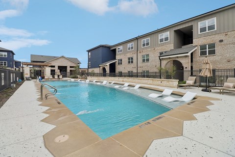 A swimming pool in front of a building.