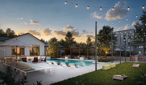 A pool area with a building and string lights.