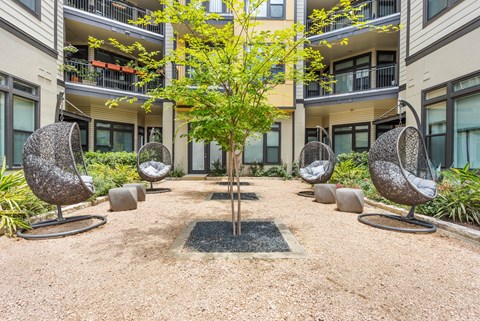 Peaceful courtyard at apartment complex with lounge chairs