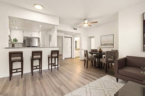 A modern kitchen with a dining table and chairs.