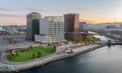 an aerial view of a city with a river and tall buildings