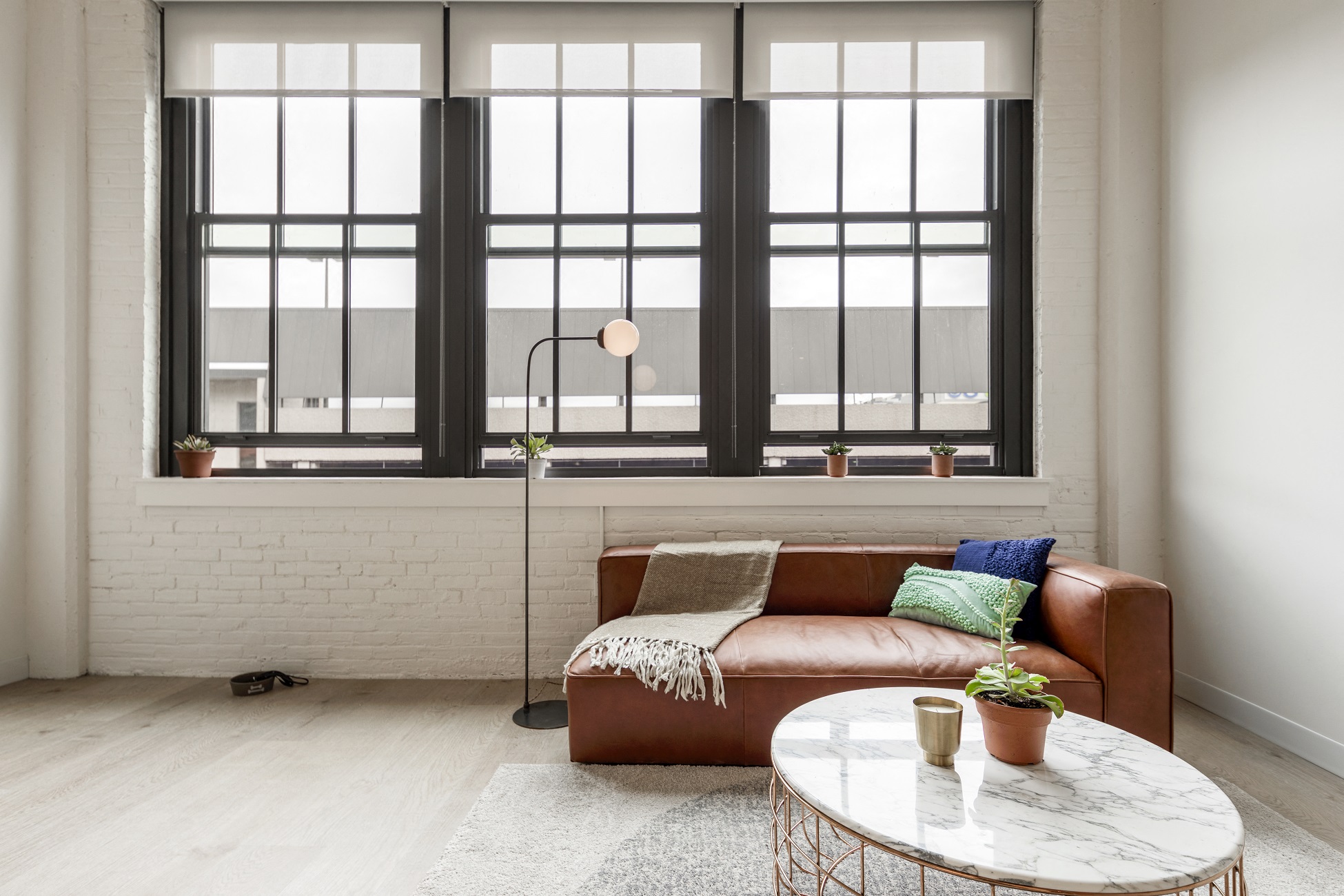 a living room with a leather couch and a table
