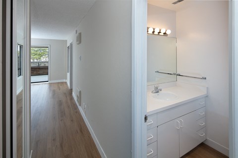 a bedroom with a medium sized bed and a mirror