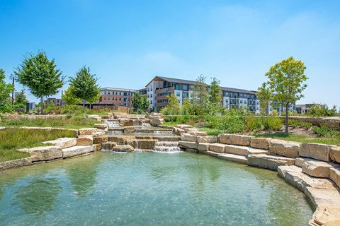 a water feature with buildings in the background