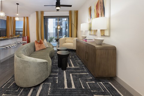 A living room with a grey chair and a brown cabinet.