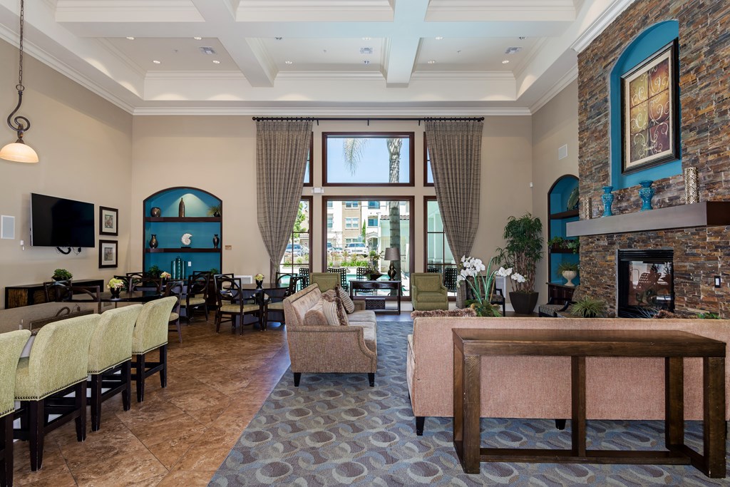 A living room with a fireplace and a large window.