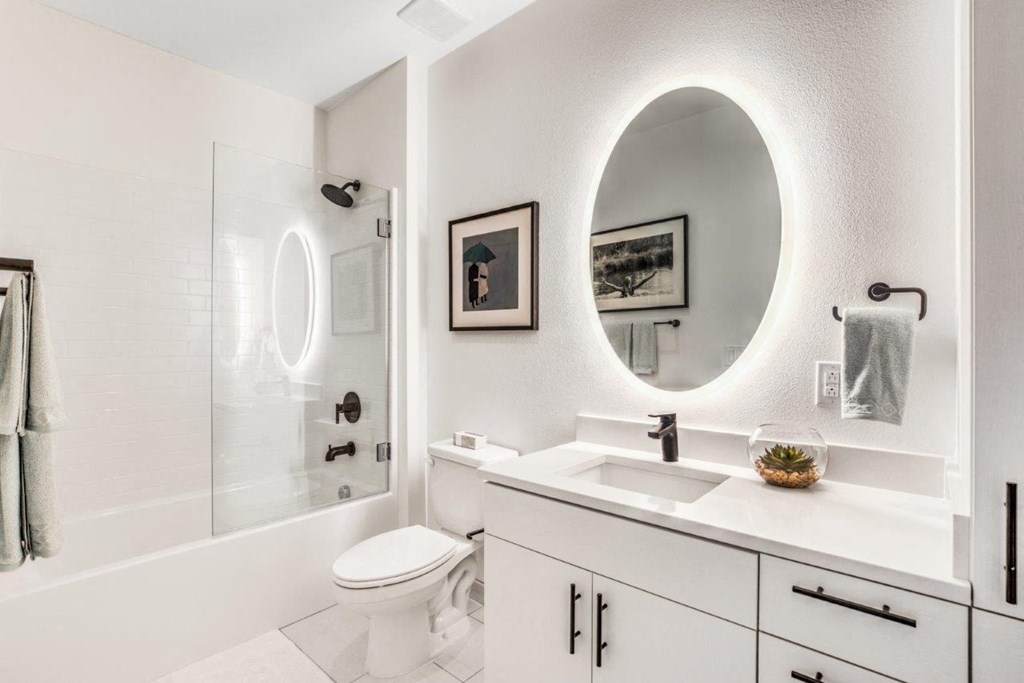 a bathroom with a sink, toilet and shower