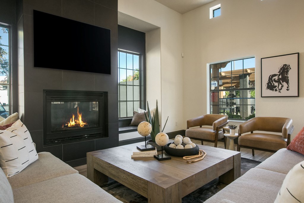 a living room with a fireplace and a tv