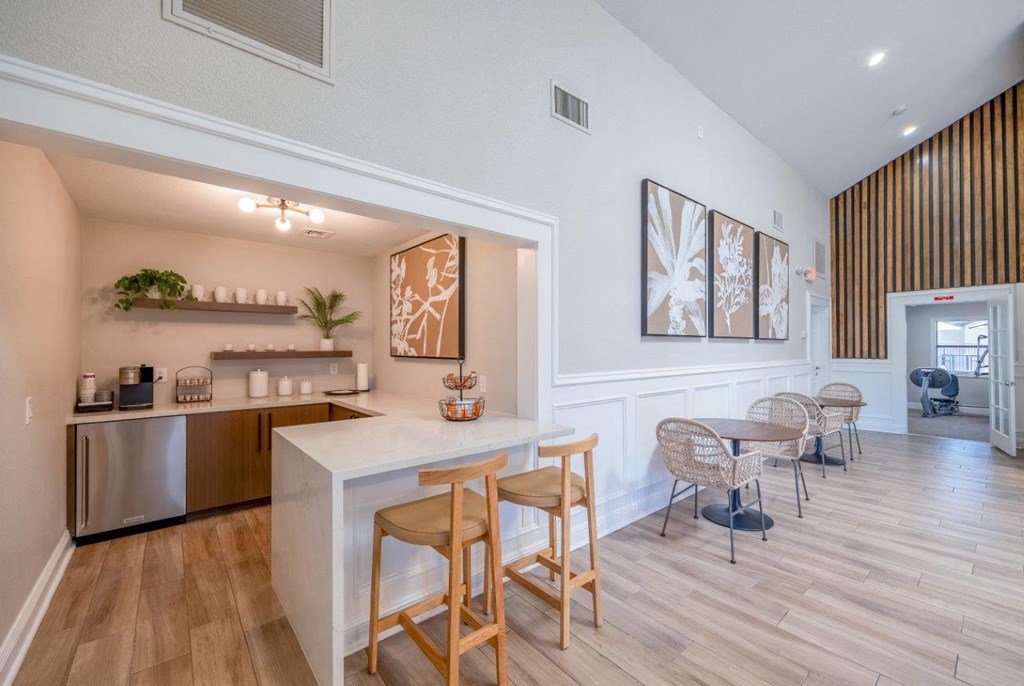 a kitchen and dining area with a bar and a living room