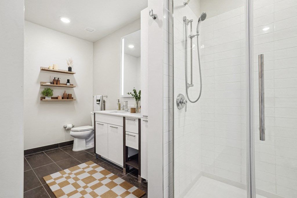 a bathroom with a shower and a sink and a toilet