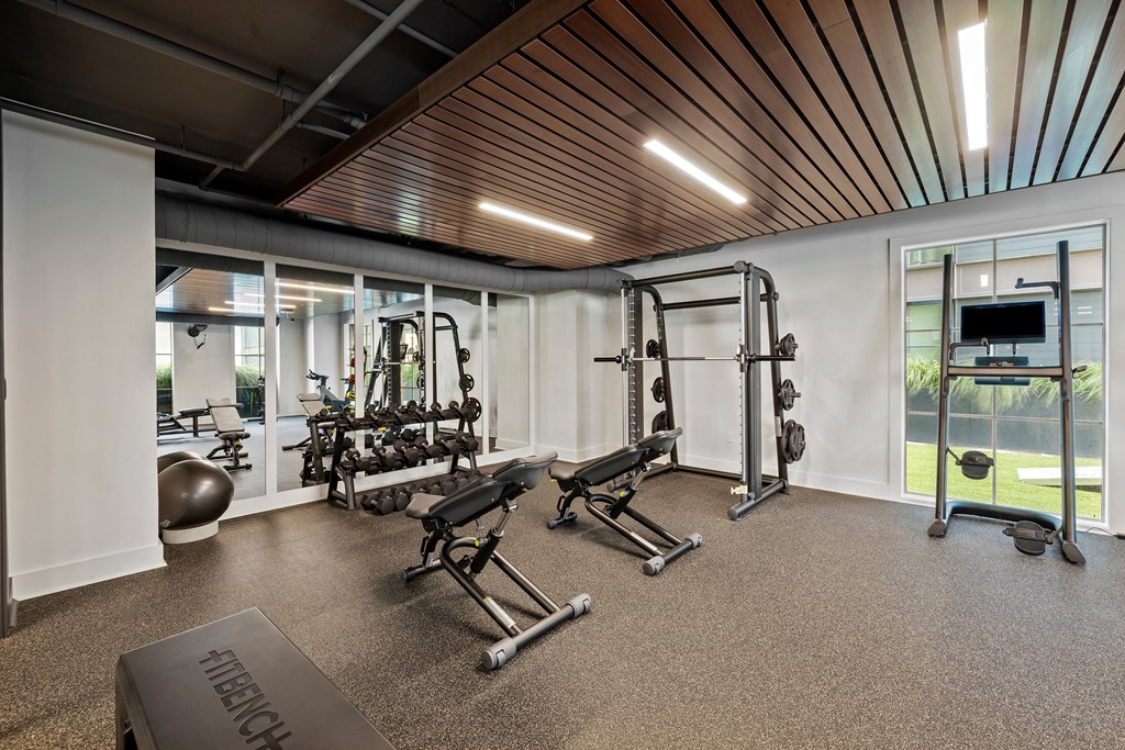 A well-equipped home gym with a variety of exercise machines.