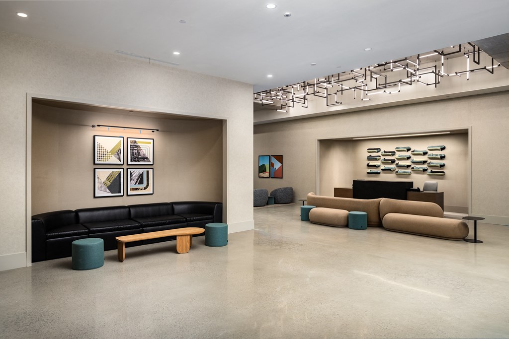 the lobby of a building with couches and a television