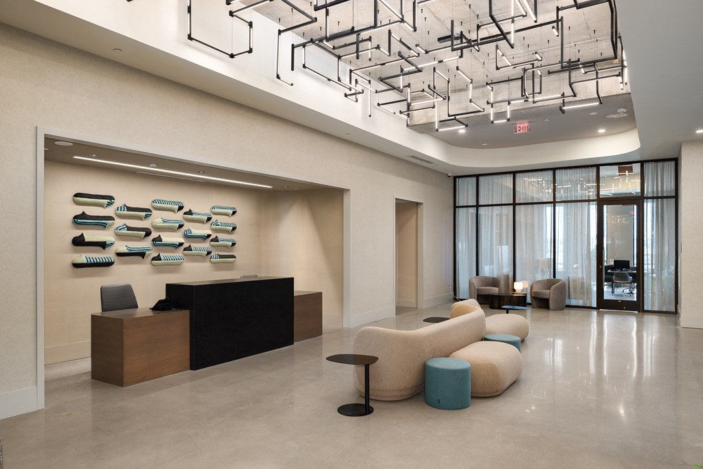 a large lobby with a reception desk and chairs