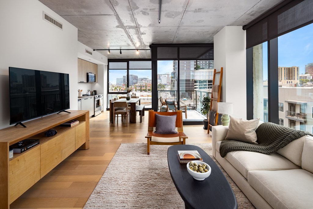 a living room with a white couch and a television