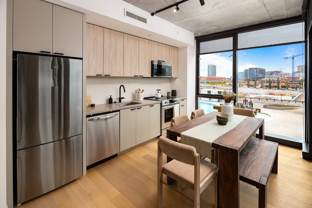 a kitchen with stainless steel appliances and a wooden table