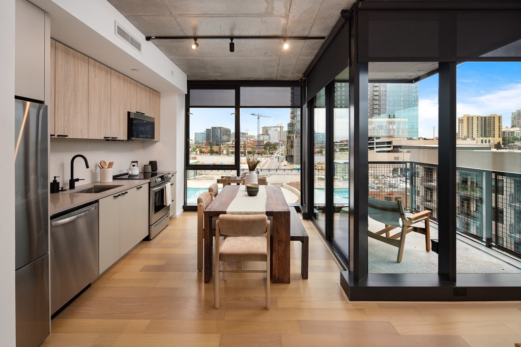 a kitchen and dining room with a view of the city