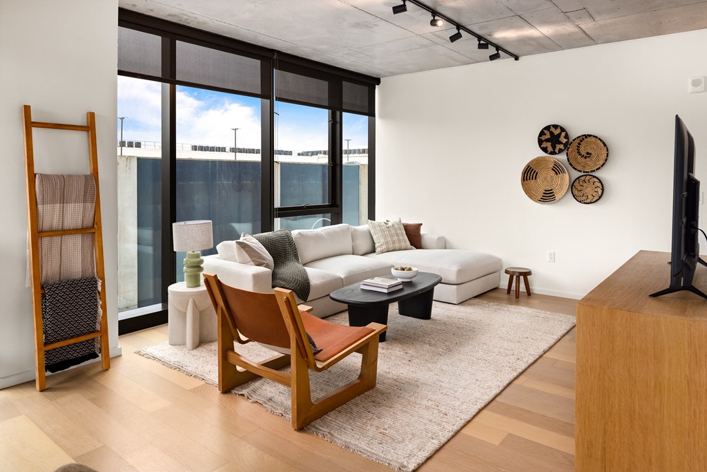 a living room with a white couch and a large window