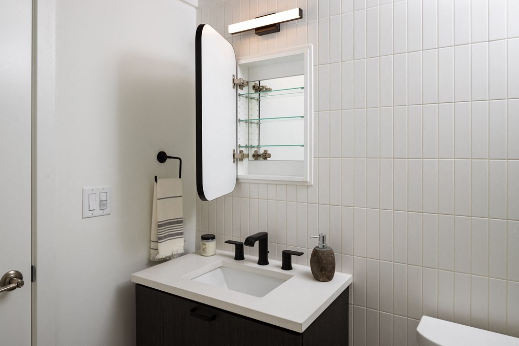 a white bathroom with a sink and a mirror