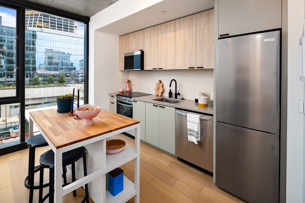 a kitchen with stainless steel appliances and a wooden table