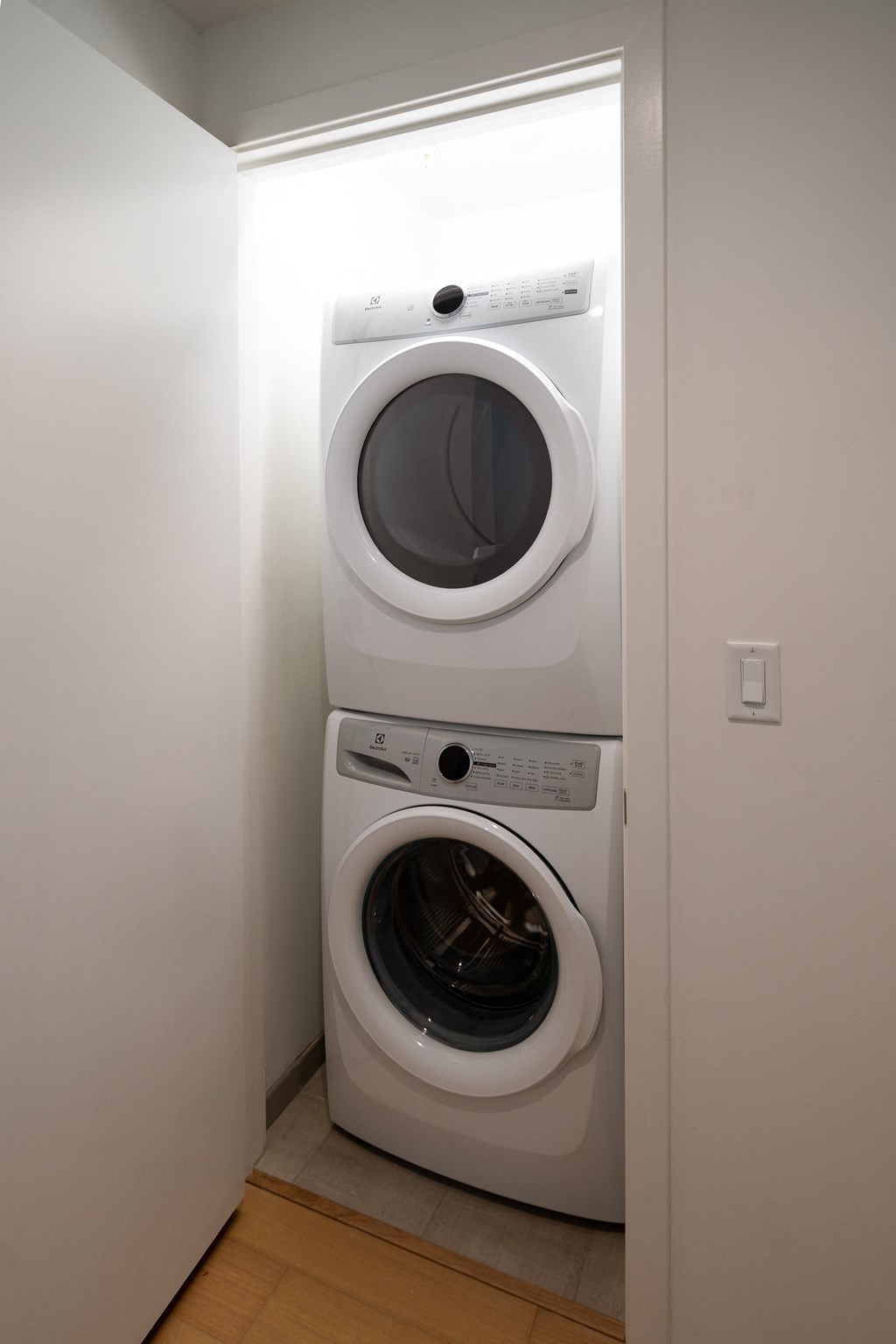 a white washer and dryer in a white laundry room