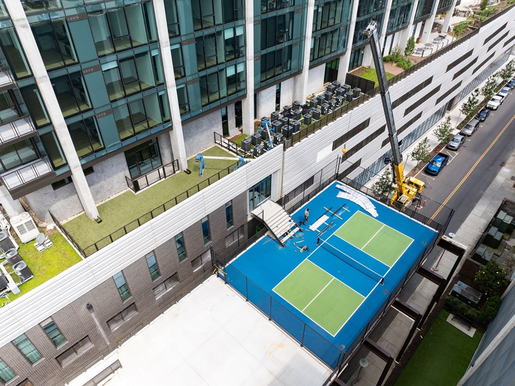 an aerial view of a tennis court on the roof of a building