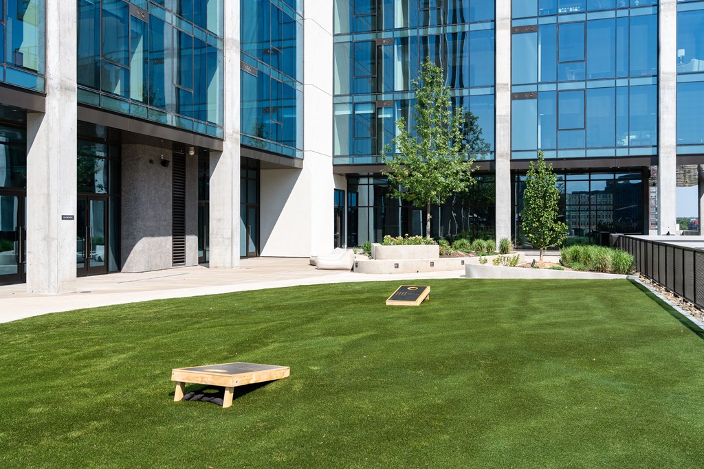 a bench on the grass in front of an office building