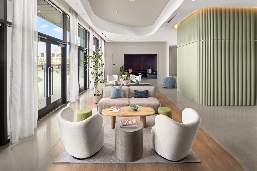 a living room with a couch and chairs and a television