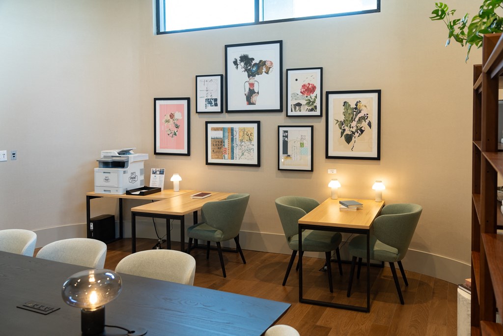a dining room with tables and chairs and pictures on the wall