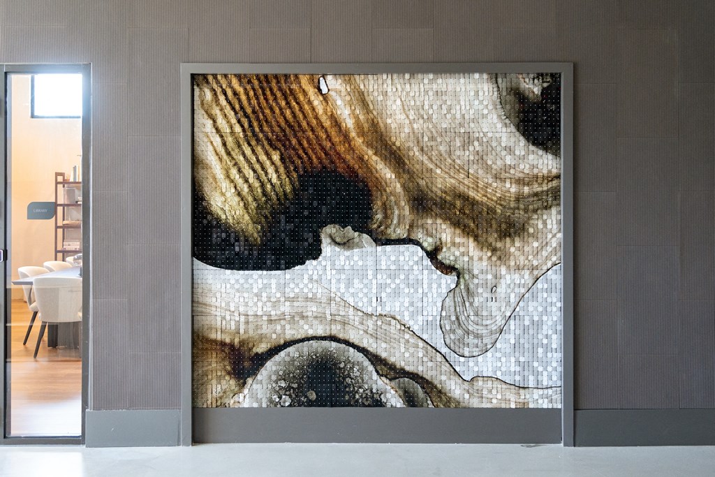 a large art piece on a wall in a room