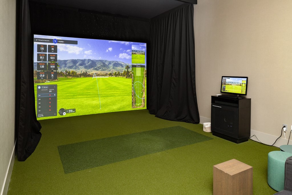 a living room with a large screen tv and a black curtain