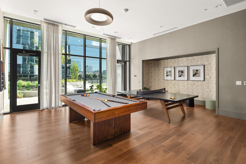 a game room with two pool tables and a billiards table