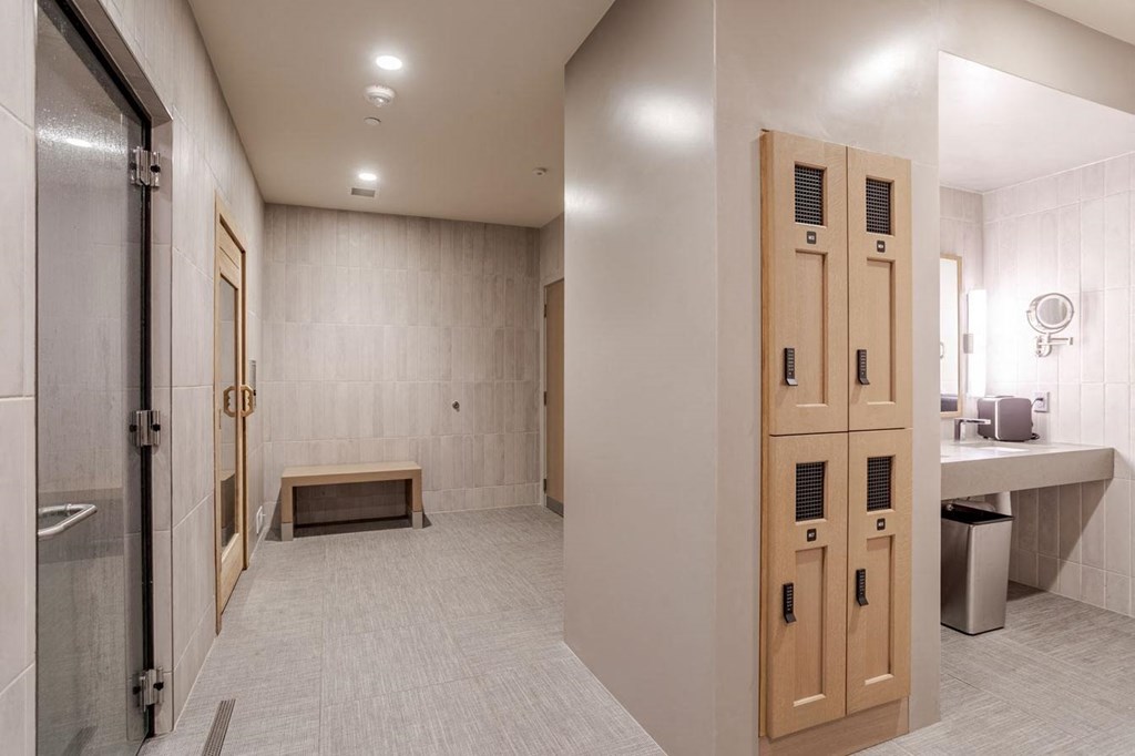 a bathroom with a row of lockers and a sink