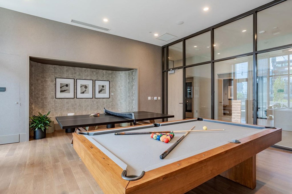 a game room with a pool table and ping pong
