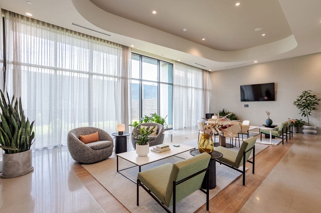 a living room filled with furniture and a large window