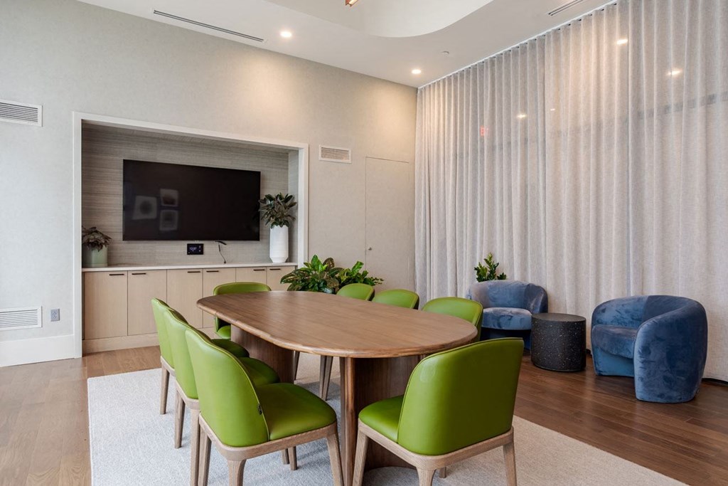 a dining room with a table and chairs and a television