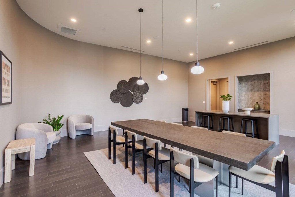 a dining room with a wooden table and chairs