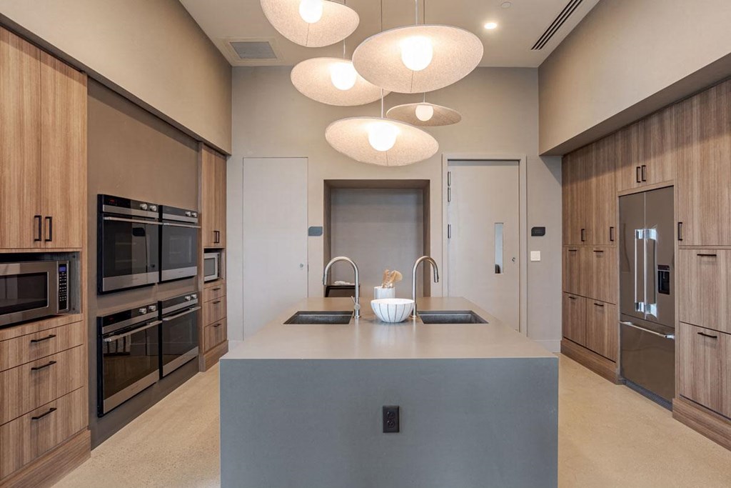 a kitchen with a large island and stainless steel appliances