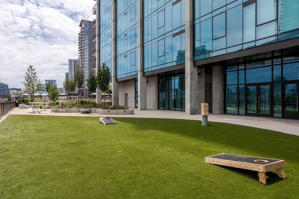 a picnic bench on the lawn outside of a building