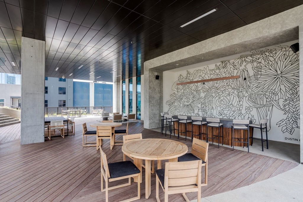 a large room with tables and chairs and a mural on the wall