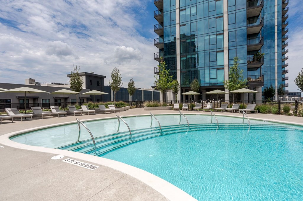 a swimming pool with a large building in the background