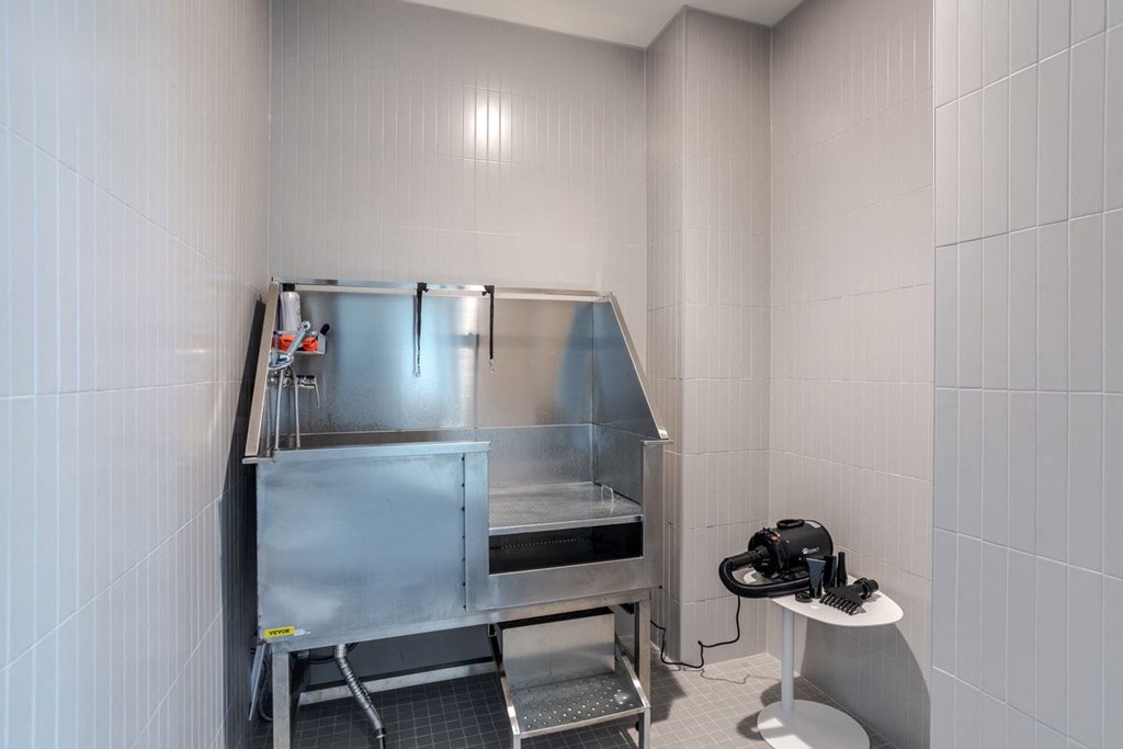 a small bathroom with a sink and a refrigerator
