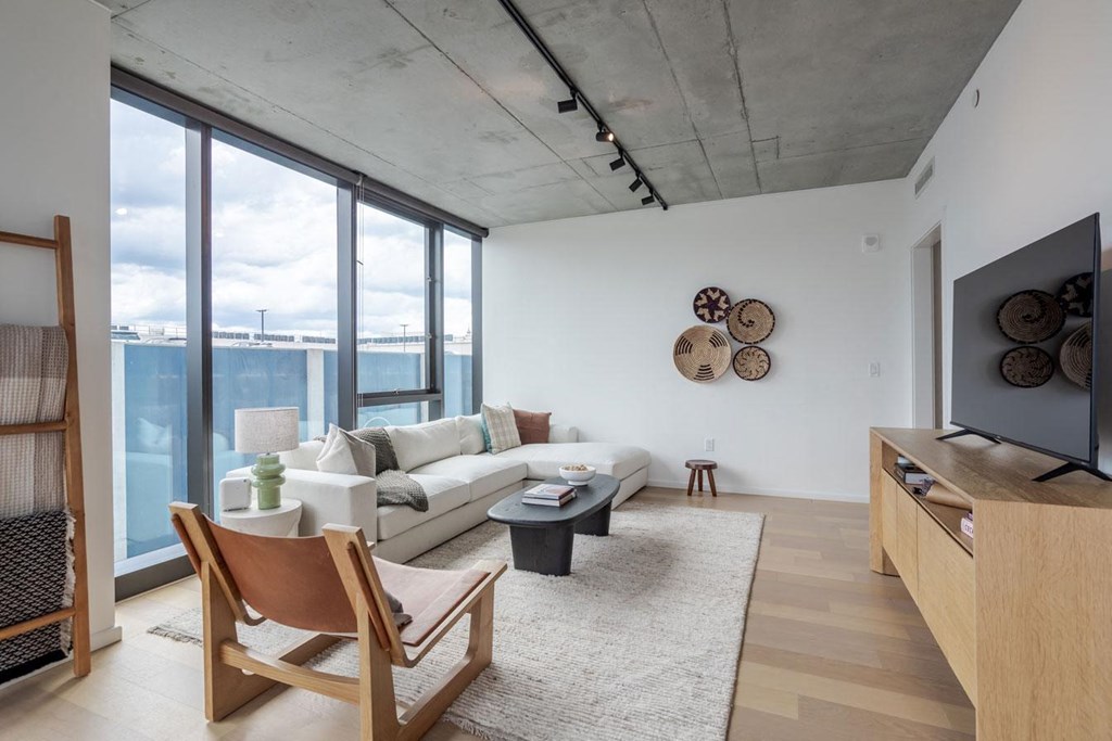 a living room with a white couch and a large window
