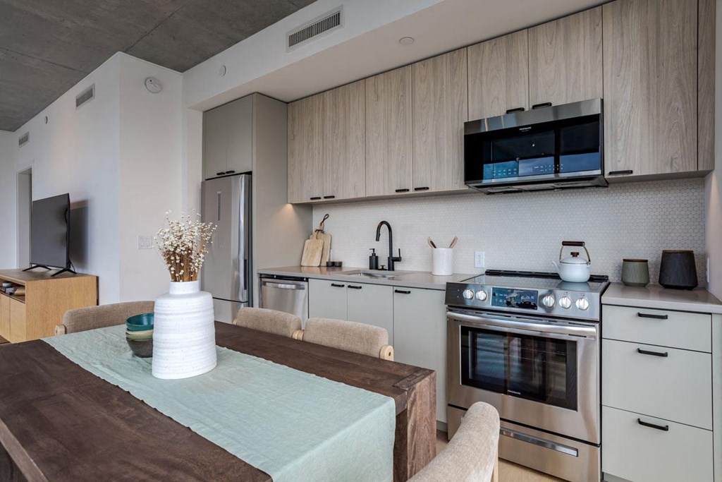 a kitchen with a table and a stove and a microwave
