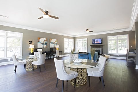 Resident clubhouse with tables and chairs at Peachtree Landing Fairburn, GA apartment rentals.