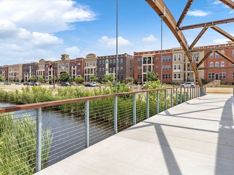 a bridge over a river with buildings in the background