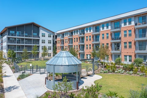 an outdoor gazebo in front of an apartment building