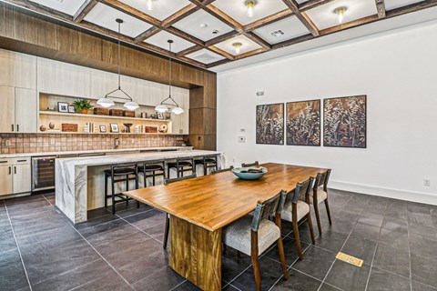 A dining room with a wooden table and chairs.